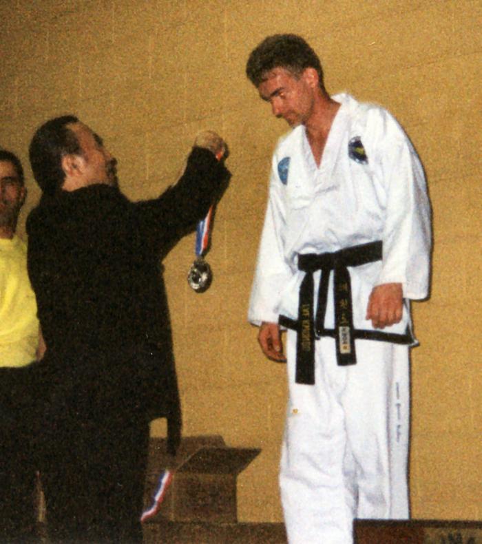 GM Hee Il Cho presenting a medal at the AIMAA World Champs, 2004
